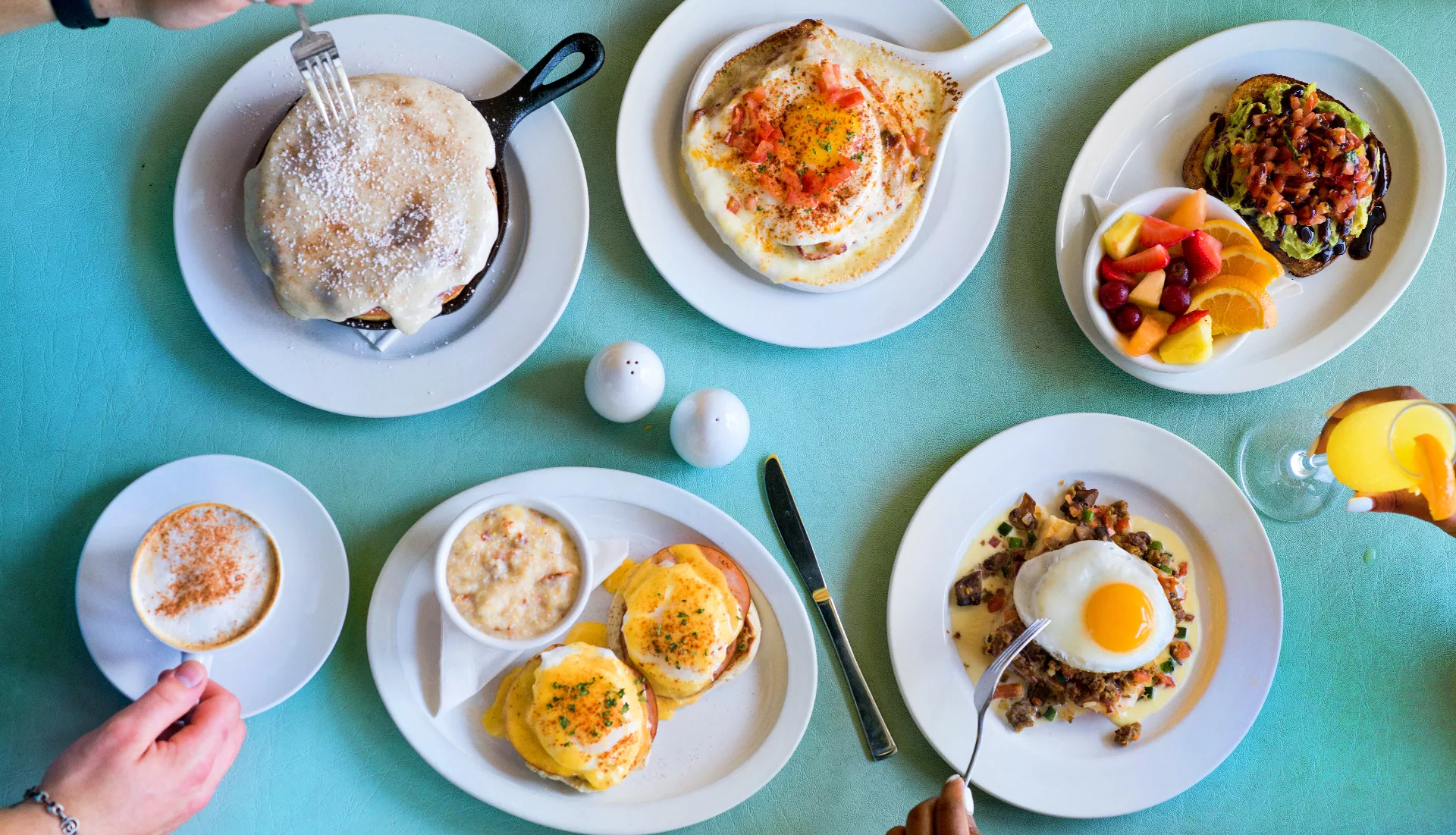 Overhead shot of fully loaded breakfast table.