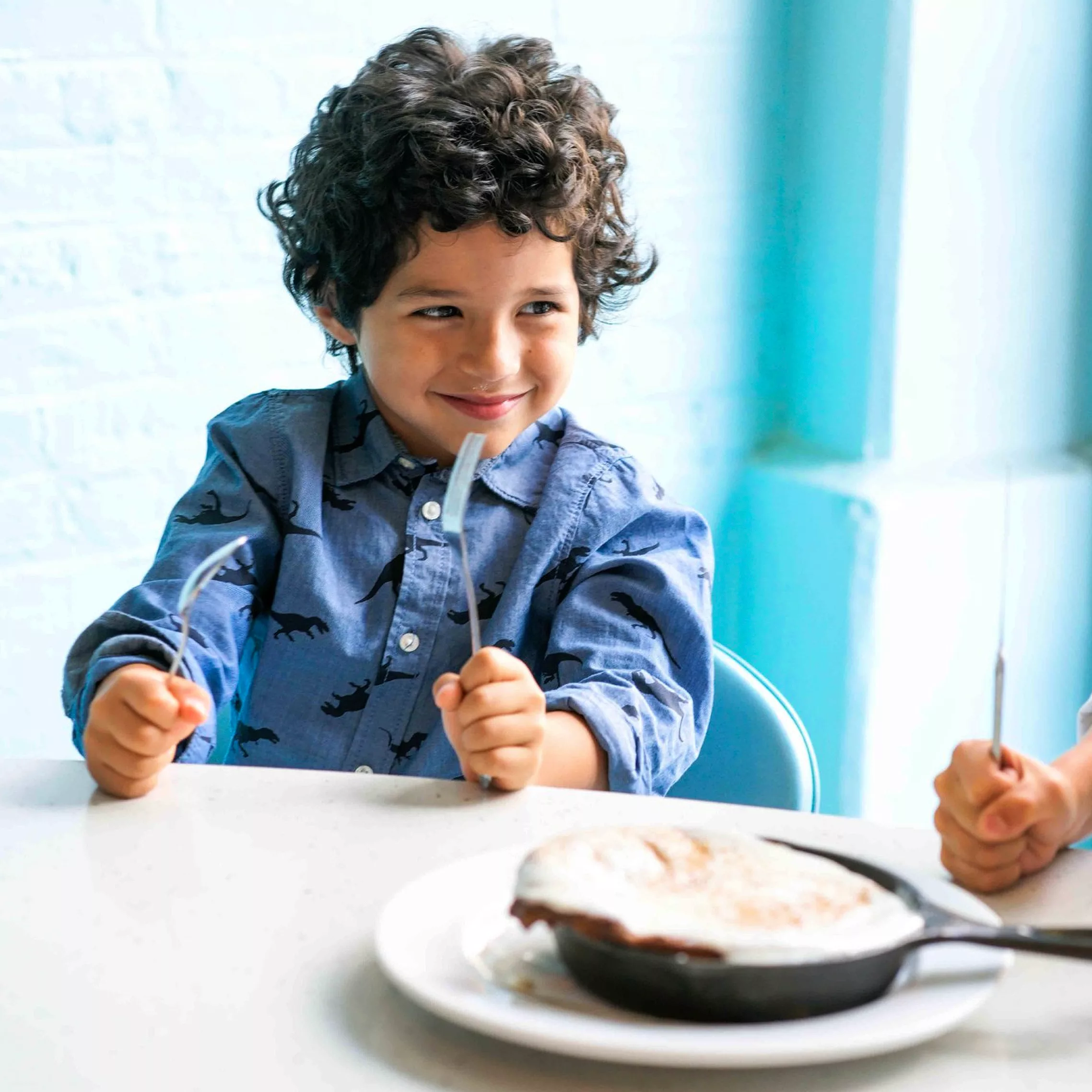 Happy boy at table.